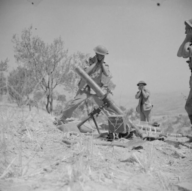 A 4.2-inch mortar of 1st Princess Louise’s Kensington Regiment in action near Adrano. 6 August 1943. [© IWM (NA 5666)]