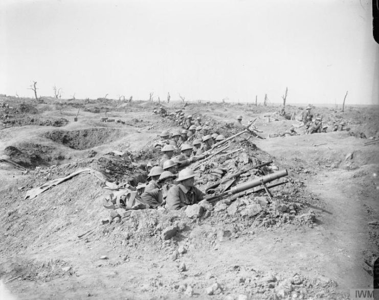 British troops awaiting orders to attack with Lewis machine guns and rifles, in reserve trenches surrounded by ruined landscape. Near Ginchy, 25 September 1916.