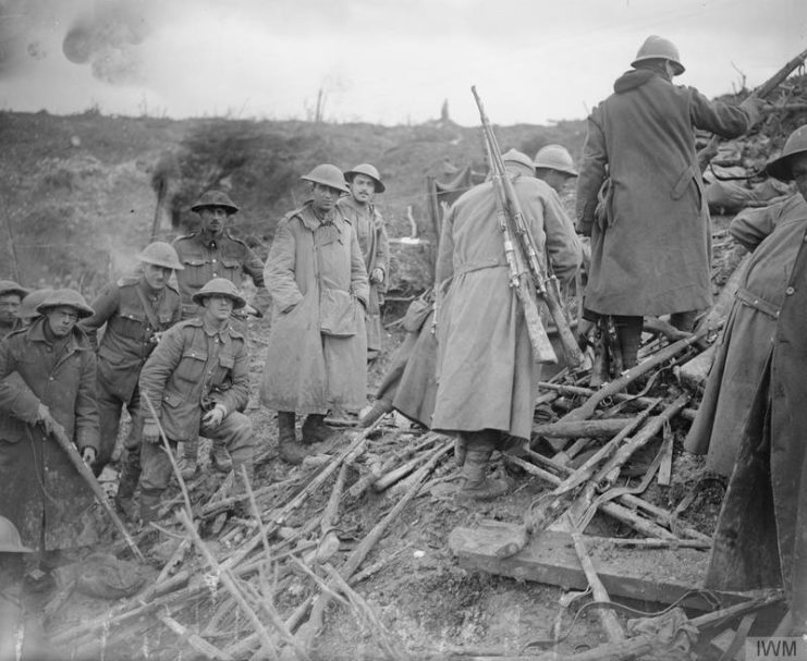 French and British soldiers salvaging German rifles at St. Pierre-Divion, captured on 13th November 1916.