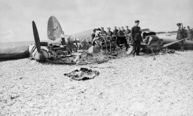 RAF personnel examine the wreck of Heinkel He 111H (G1+LK) of 2./KG 55 on East Beach, Selsey in Sussex, shot down by P/O Wakeham and P/O Lord Shuttleworth of No. 145 Squadron, 11 July 1940.