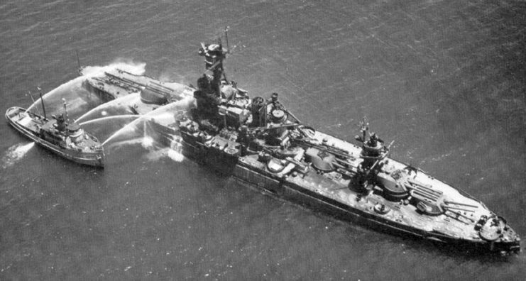 The USS New York was used as a test ship in the Operation Crossroads atomic bomb tests in Bikini Atoll. Here, a navy fireboat attempts to wash radioactive containments off New York after a test.