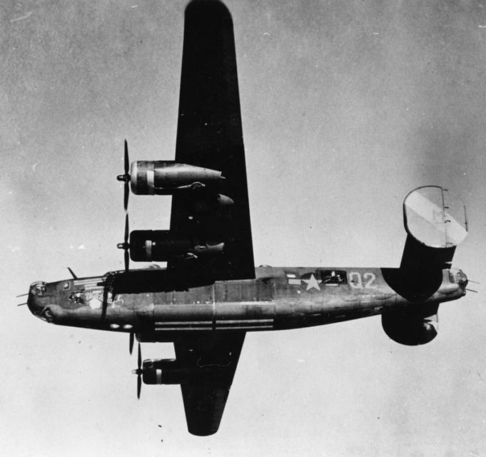 A B-24 Liberator (Q2-M_, serial number 42-52534) nicknamed Witchcraft of the 790th Bomb Squadron, 467th Bomb Group flying low above the photographer.