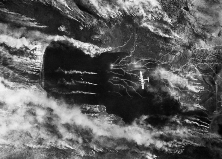 A British Lancaster bomber over Kaafjord, Norway during the Operation Paravane raid on the German Battleship Tirpitz. The smoke was intended to hide the battleship.