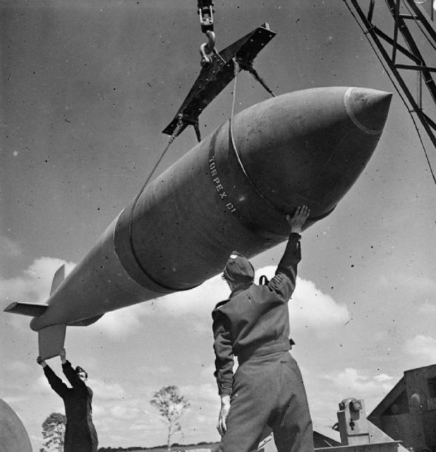 A 12,000-lb MC deep-penetration bomb (Bomber Command executive codeword ‘Tallboy’) is hoisted from the bomb dump to its carrier at Woodhall Spa, Lincolnshire, to be loaded into an Avro Lancaster of No. 617 Squadron