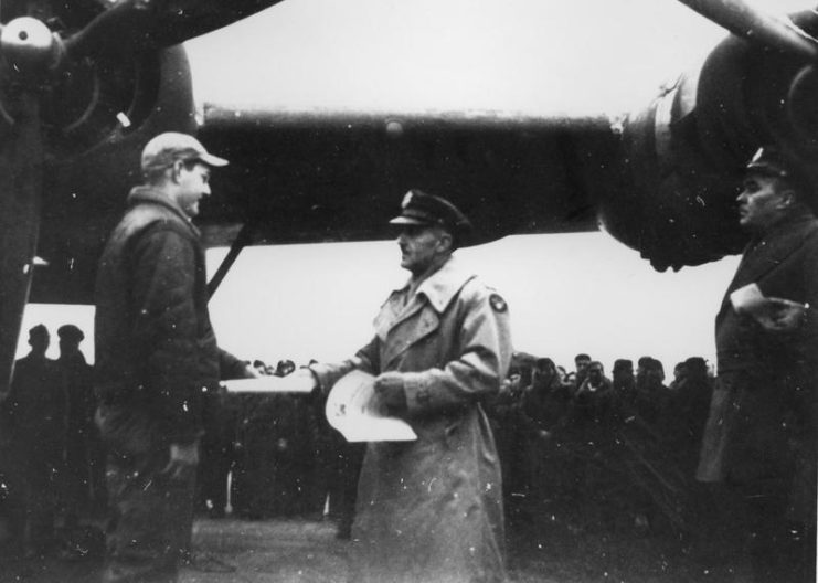 “Witchcraft” 100 mission celebration. Sgt. Raymond Betcher a member of the maintenance ground crew of B-24H-15 FO 42-52534 ” Witchcraft” receives his certificate of Meritorious service signed by General Peck and presented by Major General William E. Kepner, Commanding General of the Second Air Division, on the occasion of completion by “Witchcraft” of 100 missions with no aborts through any form of mechanical problem. “Witchcraft” went on to complete a total of 130 missions without an abort becoming one of the most celebrated aircraft in 8th Airforce history.