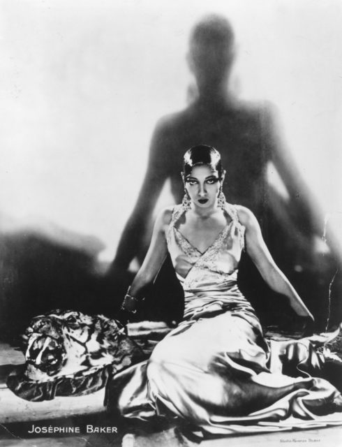 Josephine Baker sitting on a tiger rug