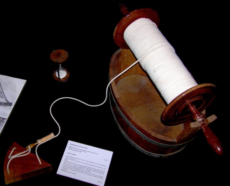 A chip log as used by the navy. The first knot can be seen below the center of the reel of rope.