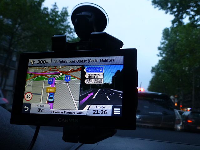 Modern GPS unit stuck to the windshield of a car
