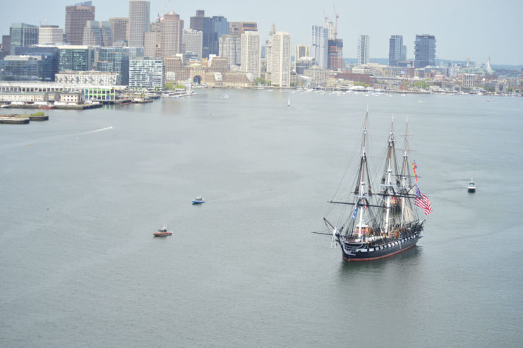 USS Constitution is tugged through the Boston harbor.
