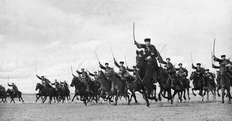 A Cossack cavalry division riding toward the Crimean Front on horseback with their sabers drawn
