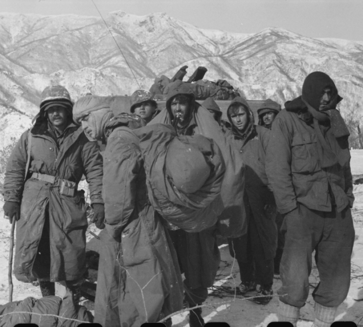 Frostbitten members of the First Marine Division and Seventh Infantry Division who linked up in the Chosin Reservoir area in a desperate attempt to break out of Communist encirclement