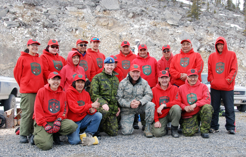 Canadian and American military brass pose with members of the Canadian Ranger Patrol Inuvik at the Mackenzie River Delta near Inuvik, Northwest Territories.