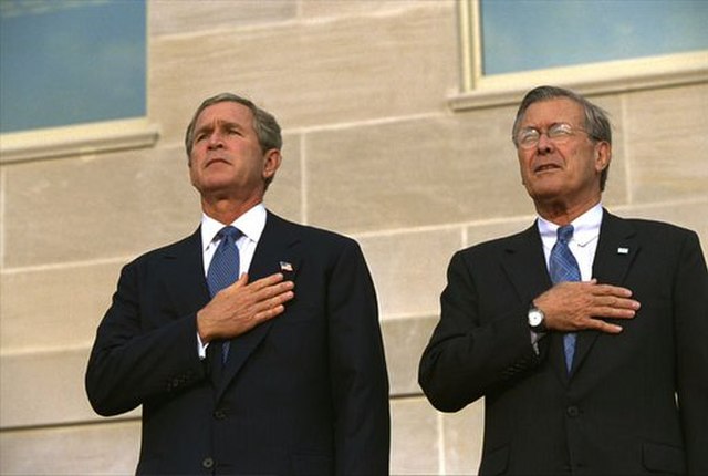 President George W. Bush and Donald Rumsfeld saying the Pledge of Allegiance