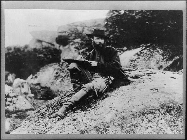 Alfred Waud sitting on a rock at devils den