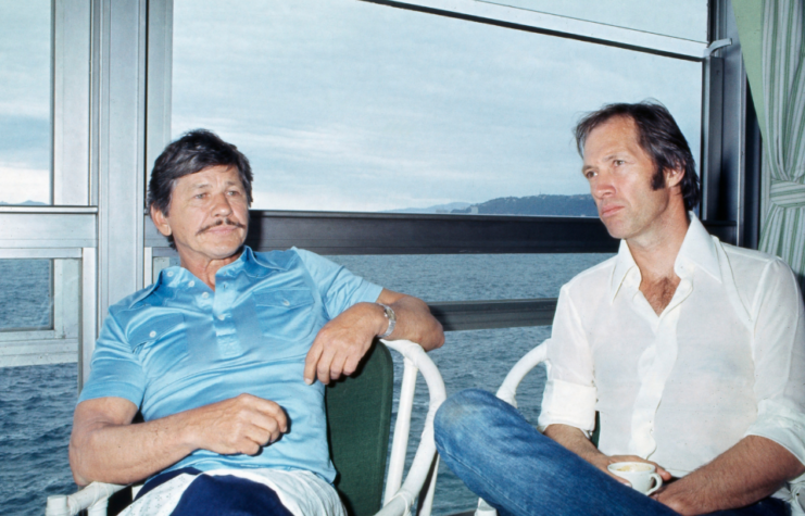 Celebrities Charles Bronson and David Carradine relaxing with a cup of coffee, Cannes Film Festival, 1977