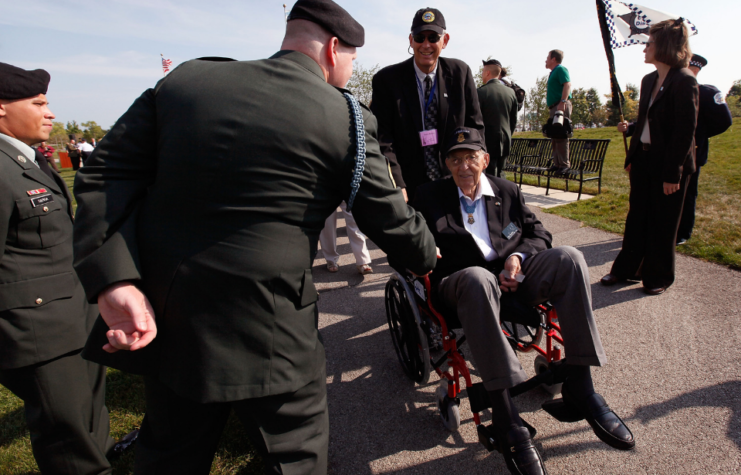 WWII veteran and Congressional Medal of Honor recipient Van Barfoot is greeted by a soldier as he heads to Soldier Field for the opening ceremony for the Medal of Honor Society Convention September 15, 2009