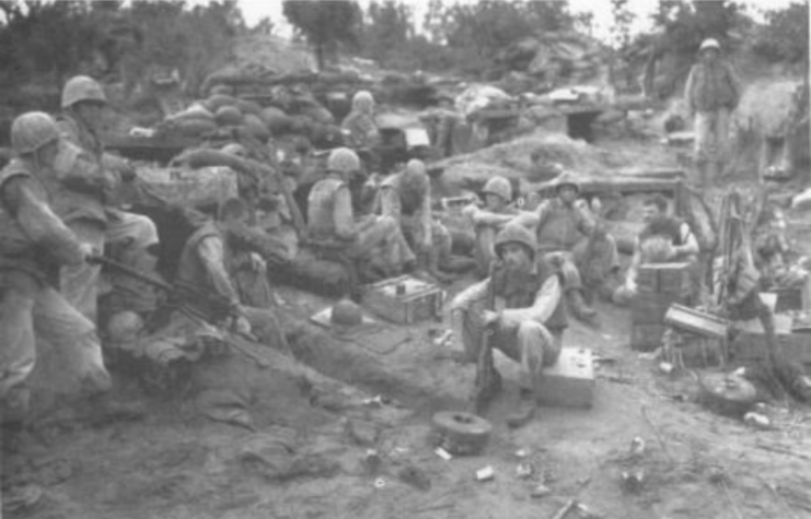 Tired Marines of Company F, 2d Battalion, 1st Marines, unwind during a pause in the fighting on Bunker Hill in Korea, Aug. 13, 1952.