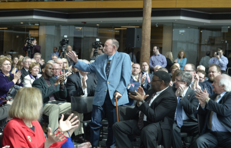 Korean War Medal of Honor recipient and Detroit native Marine Corps Pfc. Robert E. Simanek, 85, is recognized by former Sen. Carl M. Levin, elected officials and distinguished guests during a naming ceremony at the GM Renaissance Center in Detroit.