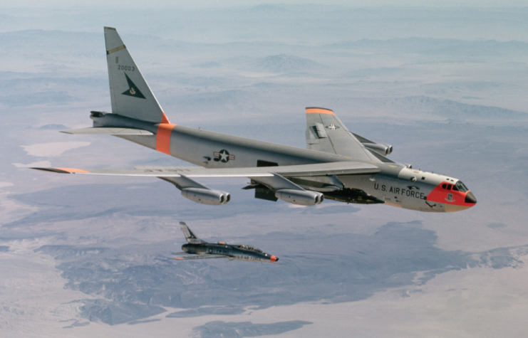 A B-52 drops an X-15 rocket plane after carrying it to launching altitude for a test flight over Edwards Air Force Base in California.