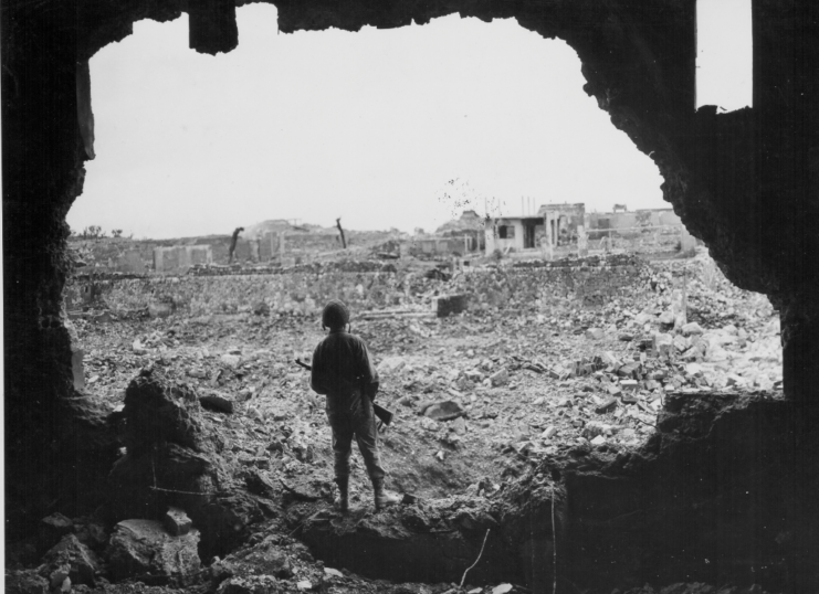 U.S. Marine rifleman viewing the results of the US bombardment of Naha, during the Battle of Okinawa, circa 1943-1945. (Photo Credit: US Marine Corps/ Getty Images)