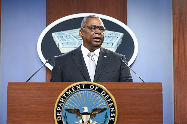 Defense Secretary Lloyd Austin standing behind a podium