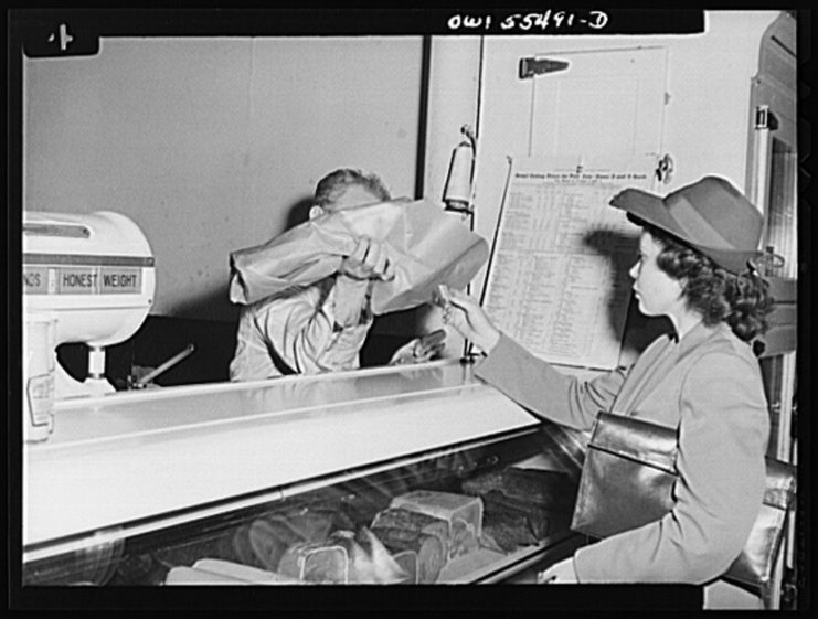 Shopper accepting a ration point bargain piece of meat