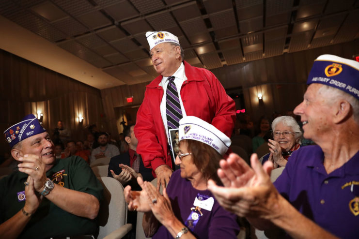 Alfred Ortiz being applauded by veterans