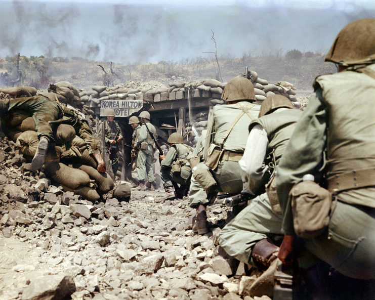 Men in military uniforms walking toward a bunker