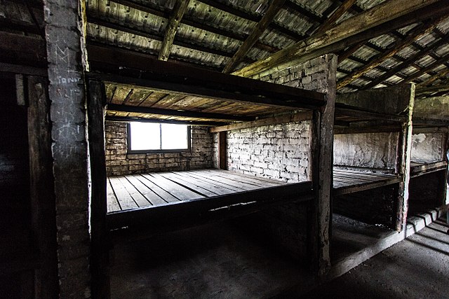 Wooden bunkbeds in a cramped building