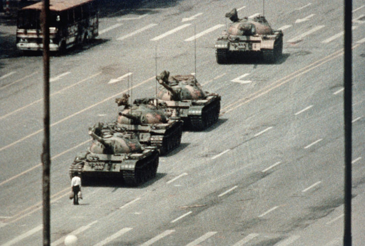 Lone male protestor blocking four tanks in the middle of the road