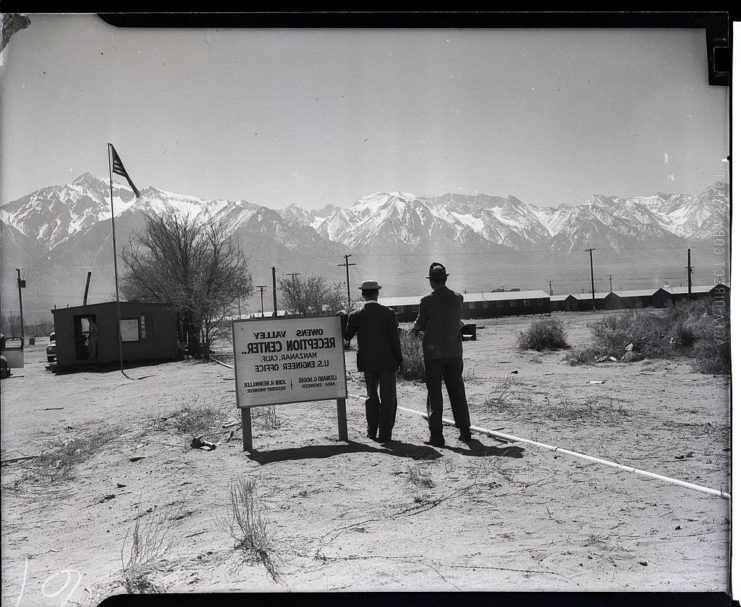 Two men standing outside the Owens Valley Alien Reception Center