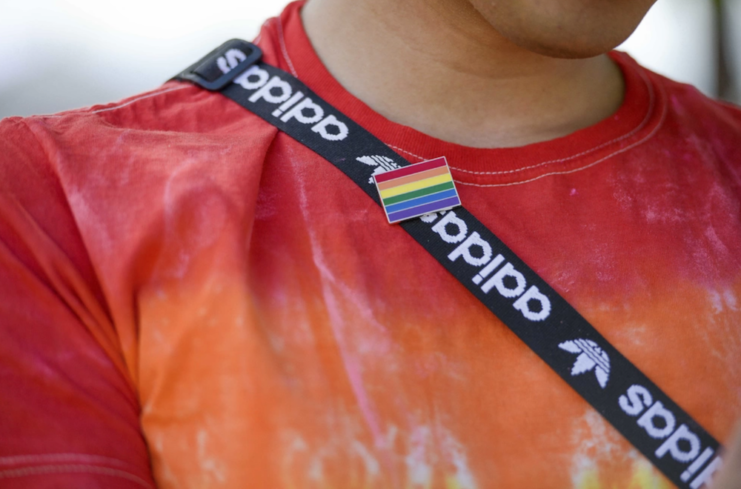 Close up of a Pride Flag pin on US Air Force Airman 1st Class Vinicio Vasquez's chest