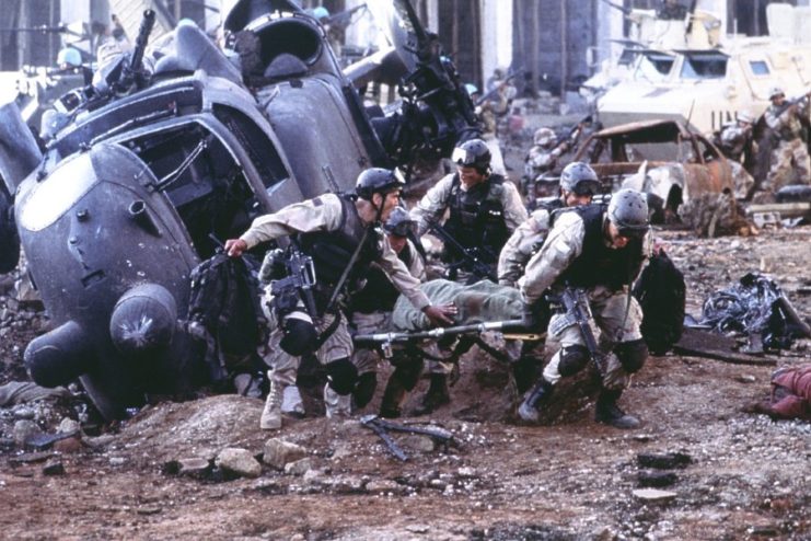 Special Forces soldiers carrying a wounded comrade from a downed Black Hawk helicopter