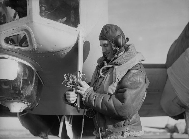 British bomber pilot holding a sprig of mistletoe