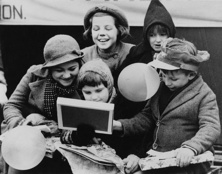 British children holding their Christmas presents