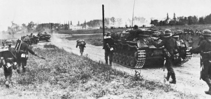 German soldiers and tanks along a dirt road