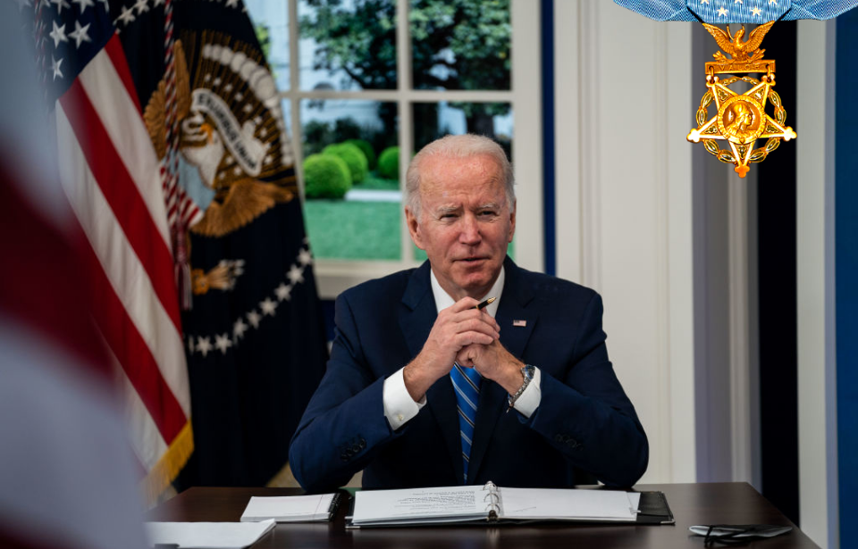 President Joe Biden sitting at his desk + Medal of Honor