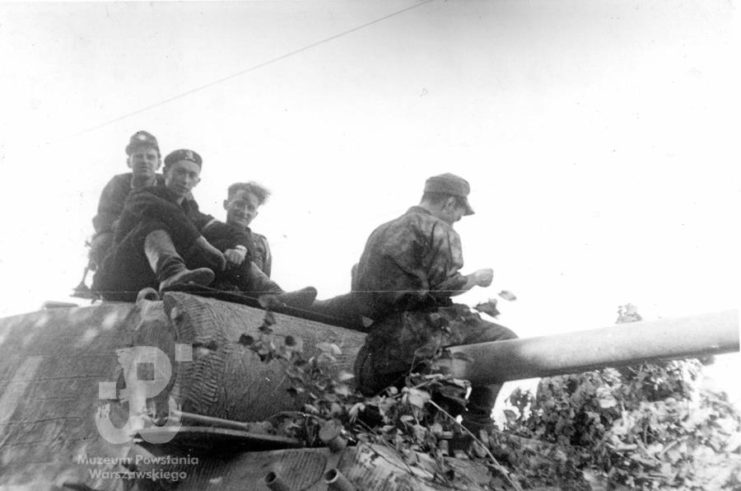 Four Scouts atop a tank