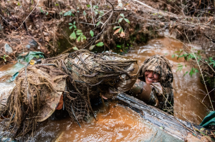 US Army Sniper School trainees in the ghillie wash