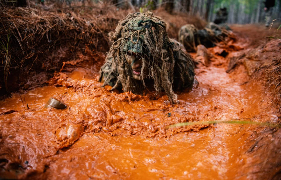 US Army Sniper School trainee in the ghillie wash