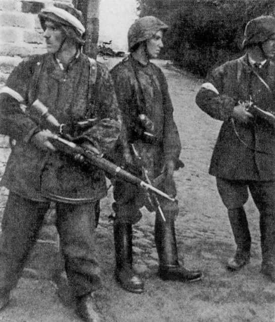 Juliusz Bogdan Deczkowski wearing German uniforms and holding guns
