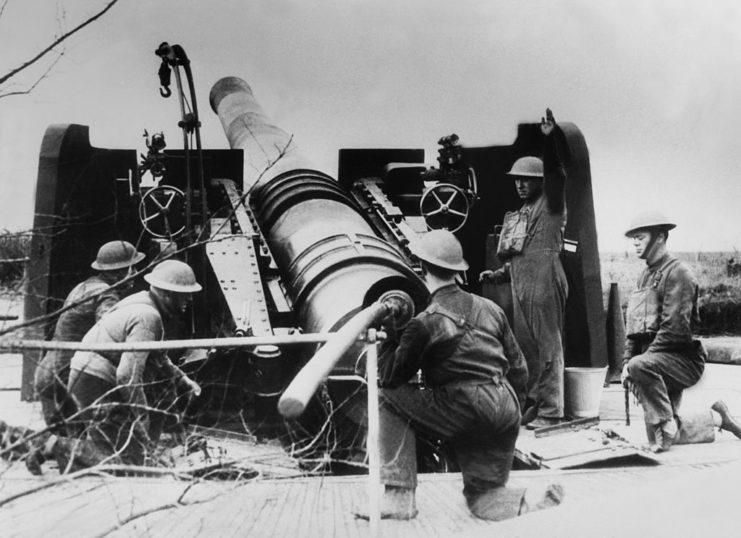 British artillerymen crouching around the base of a cannon