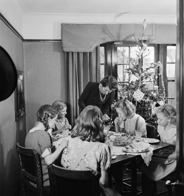 Mother serving Christmas dinner to her daughters