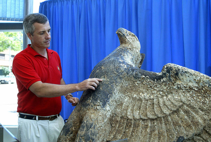 Hector Bado pointing the bronze eagle
