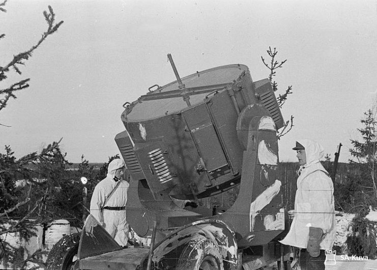 Two Finnish soldiers standing beside an anti-aircraft searchlight