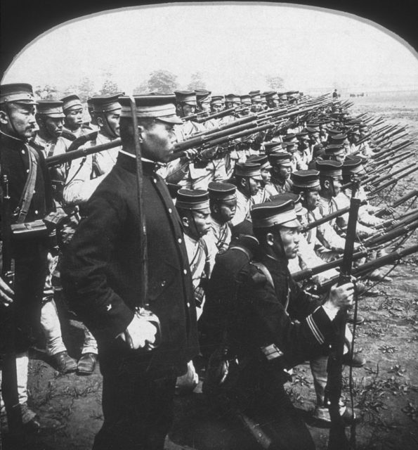 A Japanese military unit stands in fighting formation with rifles raised during the Russo-Japanese War. (Photo Credit: Hulton Archive/ Getty Images)