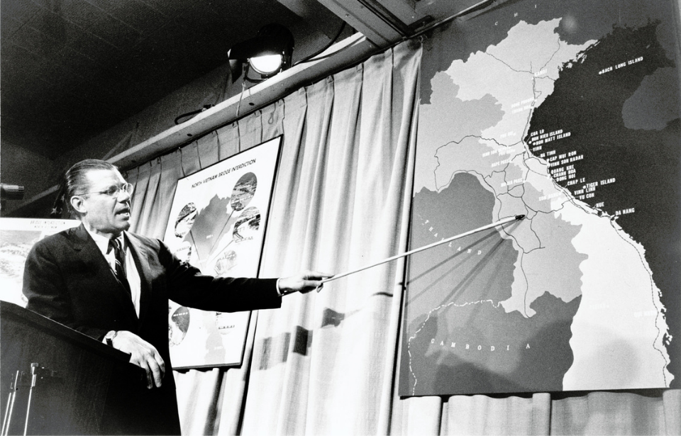 Robert McNamara pointing at a map of Vietnam