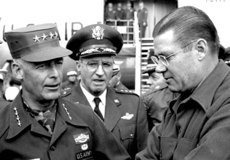 Robert McNamara standing with General Paul L. Freeman