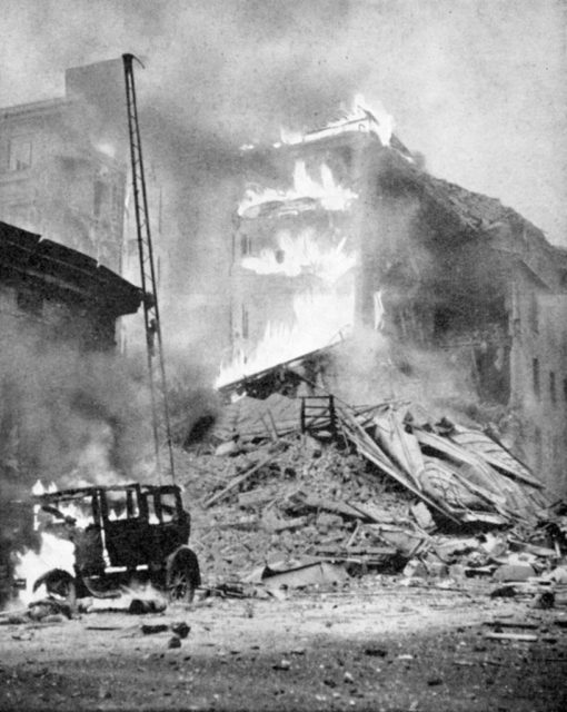 Car and apartment building on fire due to a Soviet air raid