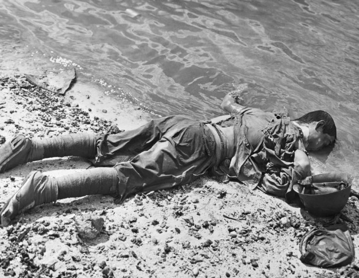 A dead Japanese soldier lies in the waves during the Battle of Saipan